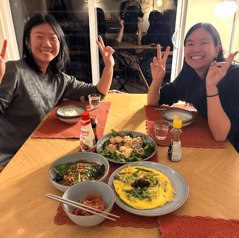 friends posing next to the food that we made for CNY